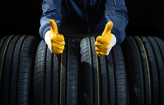 Good new tires concept with a service man fingers up
