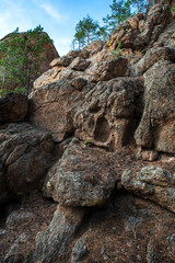 rocks with trees against the blue sky