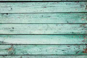 Fototapeta premium A light green old painted horizontal wooden planks texture