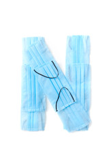 Letter N made from protective medical masks on a white background.