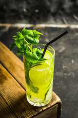 Mojito cocktail with lime and mint on the rustic background. Selective focus. Shallow depth of field.