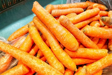 Fresh carrots and potatoes in the store. A close-up. Mobile photo.