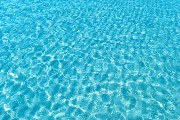 Fototapeta na wymiar Background shot of aqua water surface. Swimming pool with sunny reflections.
