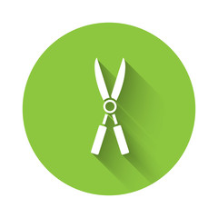 White Gardening handmade scissors for trimming icon isolated with long shadow. Pruning shears with wooden handles. Green circle button. Vector Illustration
