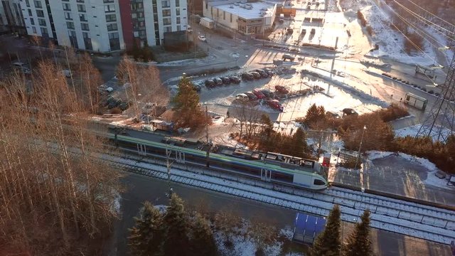 Espoo, Finland - December 24, 2017: train leaves from the station, aerial view