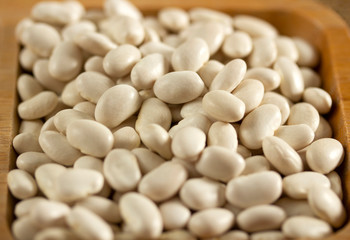 white beans in a wooden plate