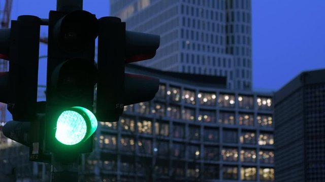 Traffic lights changing from green signal to red, taken in the evening in Berlin, Germany