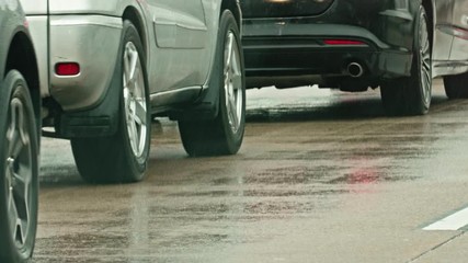 Car moving and stopping in traffic jam on rainy American highway