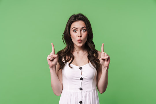 Image of amusing woman making kiss lips and pointing fingers upward