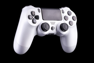 White video game joystick gamepad isolated on a black background