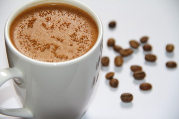 cup of coffee with beans on a wihte background