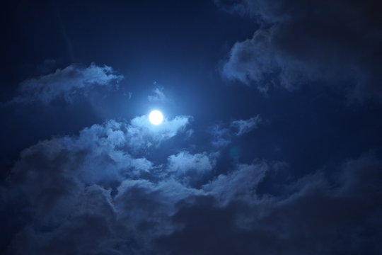 The moon night view with the round moon and clouds in the sky - Powered by Adobe