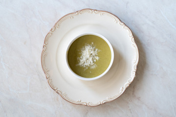 Homemade Healthy Organic Broccoli Soup with Grated Parmesan Cheese.