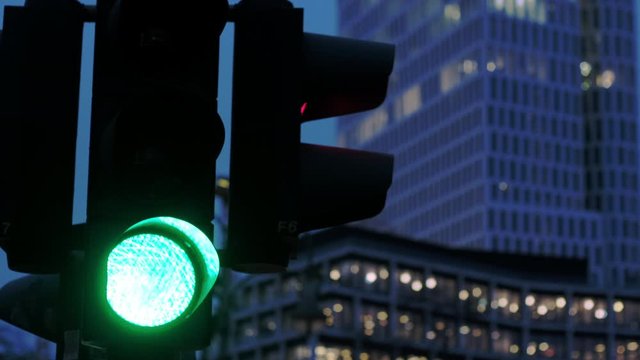 Traffic light changing from green signal to red during evening in Berlin, Germany