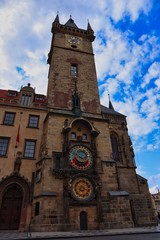 Prague Astronomical Clock in empty Prague during quarantine with beautiful clouds on blue sky.