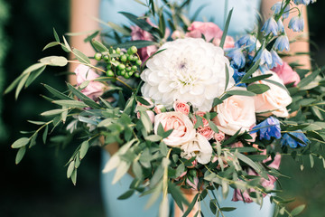 Bride in blue dress holding bouquet