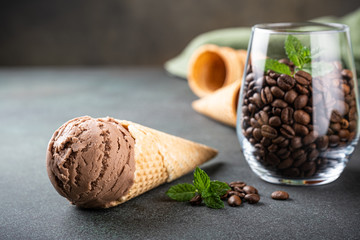 Delicious coffee or chocolate ice cream in waffle cone for dessert. Summer healthy food concept, lactose free. Copy space.