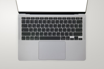 Close-up top view of ultrabook, a thin and light laptop, in space grey color on white isolated...