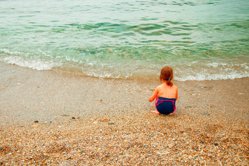 Summer holiday and leisure concept. Child girl in sea. Free space for design.