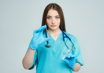 a female doctor holds an ampoule and a syringe in her hand