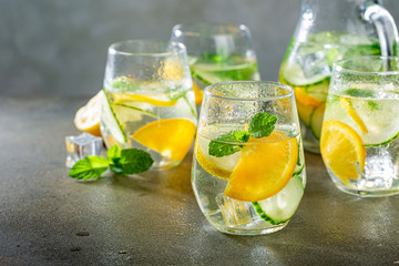 Summer healthy lemonade, cocktails of citrus infused water or mojitos, with lime lemon orange, ice...