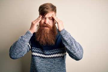 Handsome Irish redhead man with beard wearing winter sweater over isolated background with hand on...