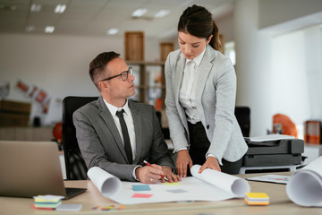 Colleagues in office. Businesswoman and businessman discussing work in office. 
