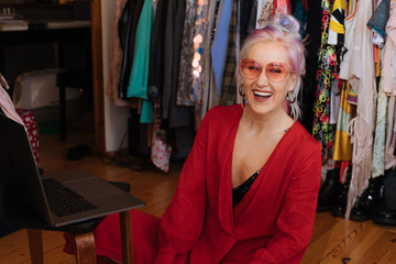 Smiling woman in wardrobe. Young female social media Influencer recording video at home doing online job interview conference call vlog. Social distancing vloger fashion and beauty content creator