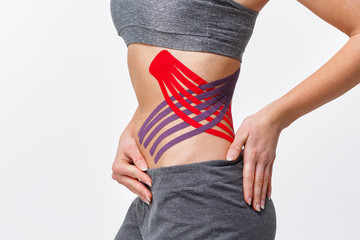 Weight loss concept. Kinesiology taping.Anti-cellulite procedure for slim belly.Close up view of...