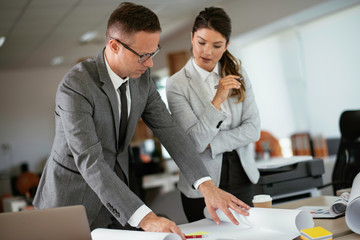 Colleagues in office. Businesswoman and businessman discussing work in office. 