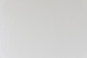 The modern texture of the striped wallpaper that is mounted on the concrete wall in the bedroom