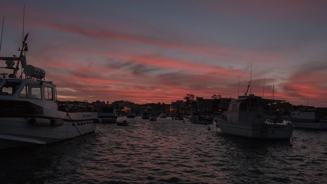 Stunning Sunset With Vibrant Red Sky Over Birzebbuga Fishing Village in Malta