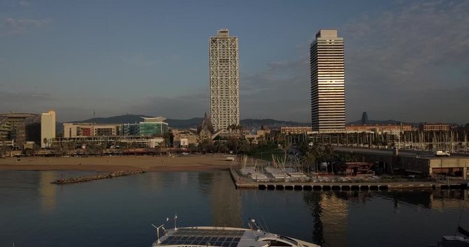 Aerial Truck Right Port Olimpic boats docked & Mapfre Tower in background