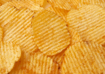 texture of round fried potato corrugated chips, full frame