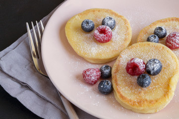 Cottage cheese pancakes, syrniki with fresh berries.