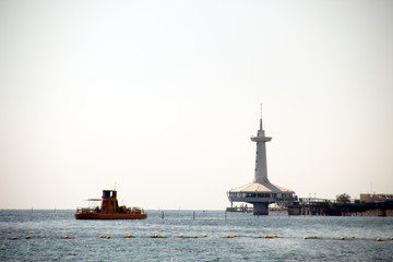 Fototapeta premium Photo with marine landscape in Eilat, Istael. View with lighthouse and yellow boat.