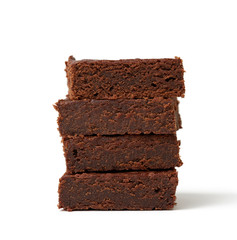 stack of square baked pieces of brownie chocolate cake isolated on a white background
