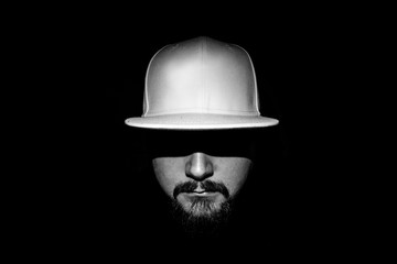 low light portrait of a man with a white cap moustache and beard