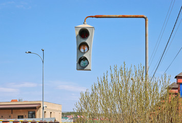 Vintage old traffic light on a rusty post. Close-up.