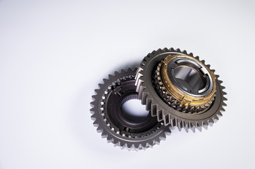 New parts on a gray background. Gears of gear shifting torque transmission. Conceptually mechanical...