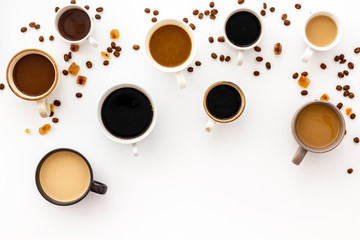 Cups of hot drinks on white table top-down space for text