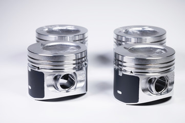 New parts for the internal combustion engine. Pistons on a gray gradient background
