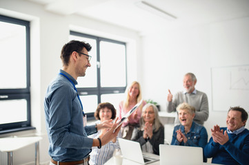 Group of senior people attending computer and technology education class.