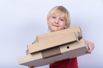 Blond boy holding pizza boxes on white background. Meal delivery to home concept.