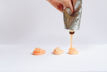 Squeezed out tubes of hair dye on a white background