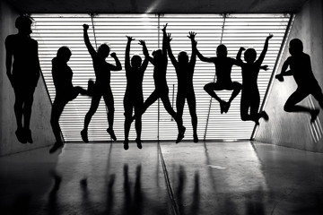 silhouettes in the backlight, a team of pilots in a wind tunnel hangar