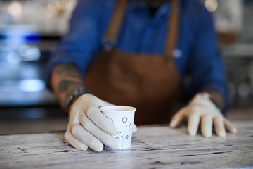 Barista working with gloves, coffee shop open after lockdown quarantine.