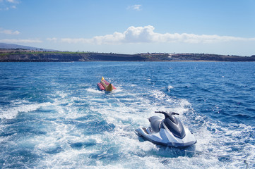 Jet Ski and inflatable banana towed by a boat