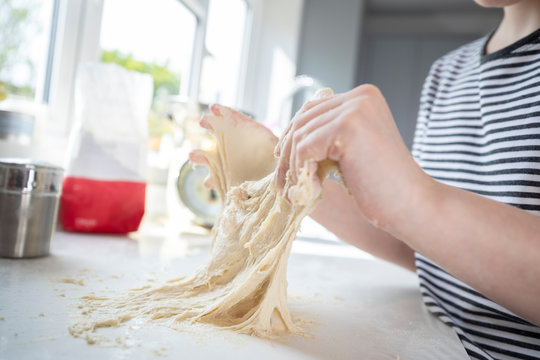 Close Up Of Portrait Of Girl With Messy Hands Having Fun In Kitchen Kneading Dough For Baking