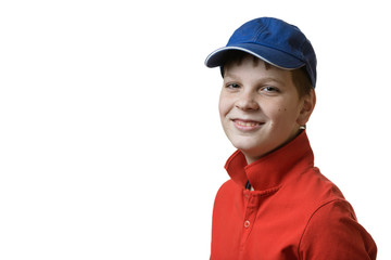 Portrait of a teenager boy in a red T-shirt and a blue baseball cap on a white background, smiling, isolate, copy space